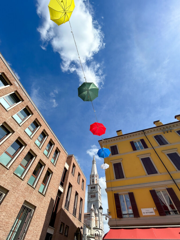Street with umbrellas in Modena, Italy