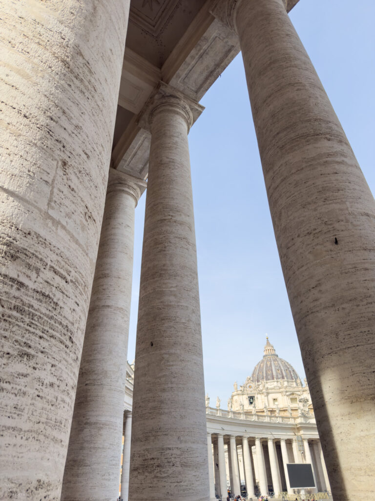 View of St. Peter's Basilica between pillars from St. Peter's Square